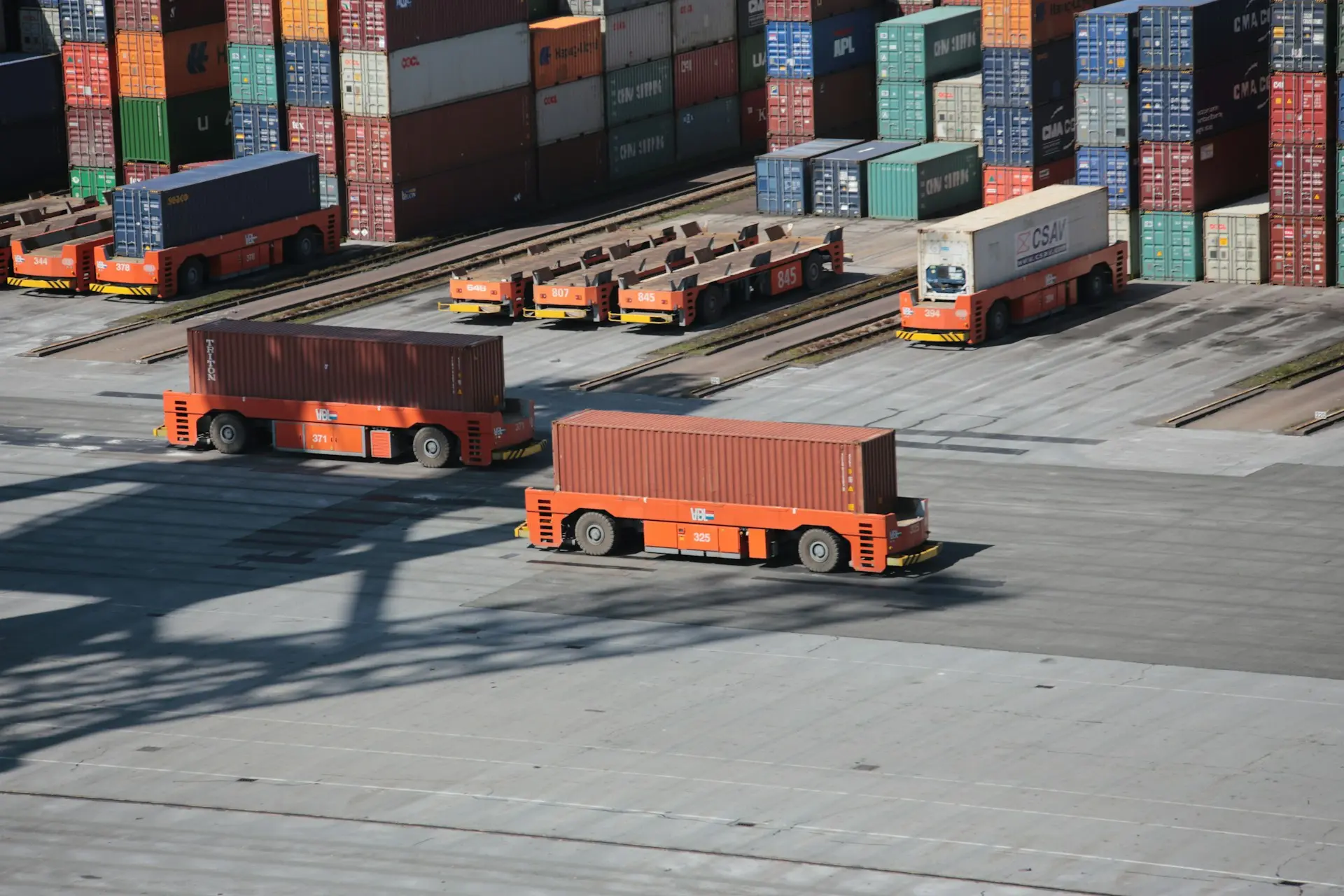 Crated surplus machinery loaded onto a trailer for cross-border export
